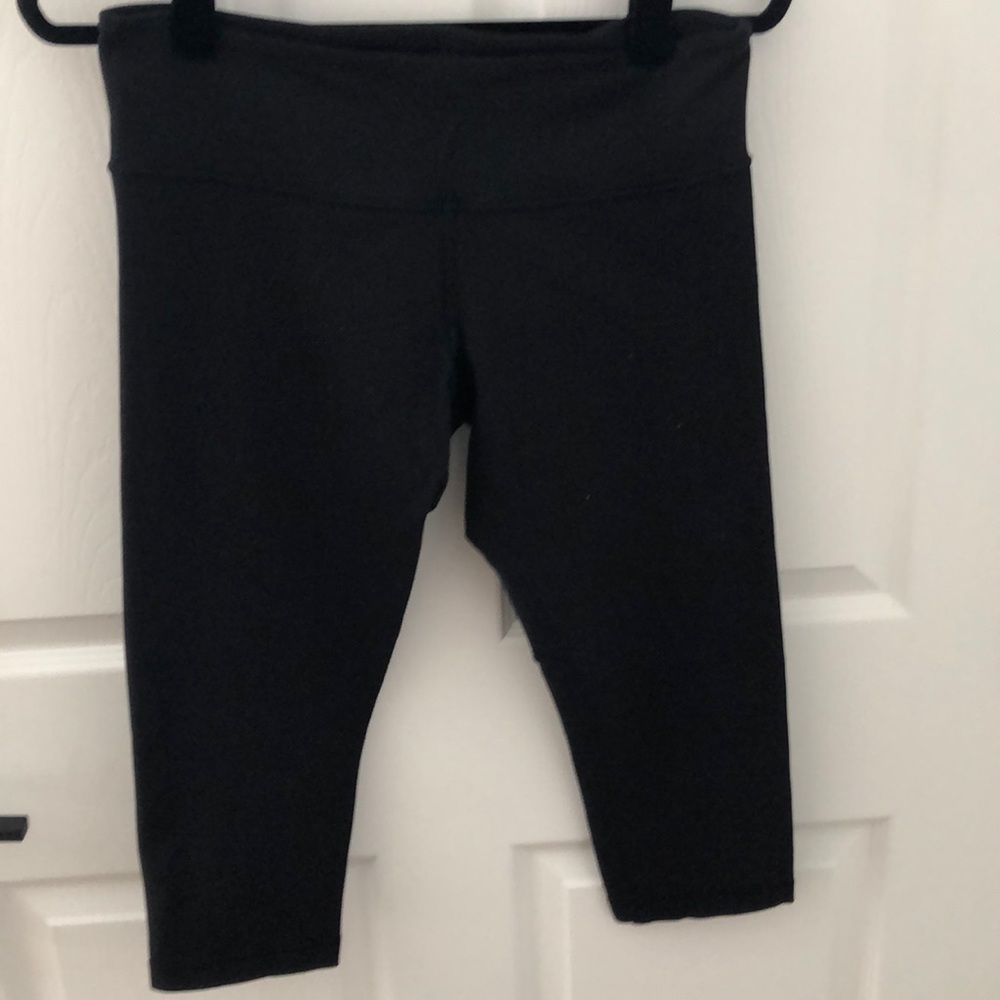 Black Lululemon Wonder Under crops.